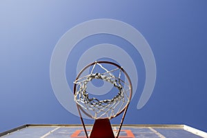 Basketball ring and board with white net.