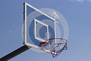 Basketball shield in the open air . Outdoor basketball ring in front of blue sky background. Sport concept