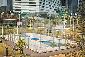 Basketball and soccer court outdoor with city background