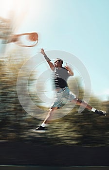 Basketball, sports and goals with man and jump in park court training for fitness, health and workout. Energy, action