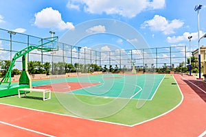 Basketball stadium playground with blue cloudy sky photo