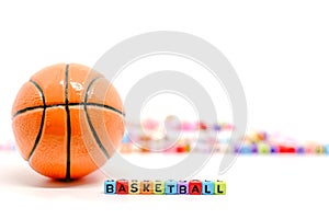 BASKETBALL word from alphabet letter beads and blurred colourful