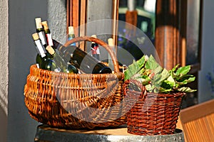 Baskets with bottles of wine and salads