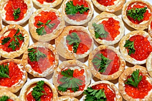 Baskets with butter, red caviar and parsley