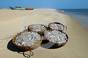 Baskets with a fish on seacoast.