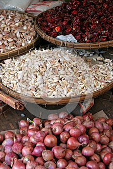 Baskets of garlic, chilli and onions. photo