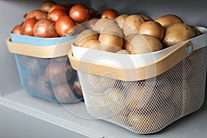 Baskets with potatoes and onions. Orderly storage