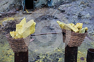 Baskets of sulfur ore mined from Mount Ijen, Indonesia.