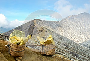 Baskets of sulphur in Kawah Ijen