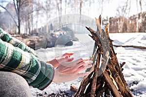 Basking near a campfire in a snowy birch forest