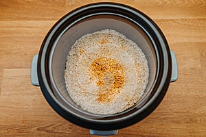 Basmati rice cooking in electric rice cooker with Turmeric, Curcumin, salt and pepperr