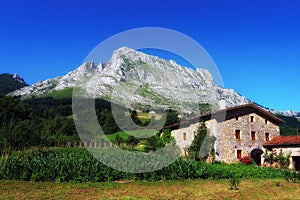 Basque farmhouse under Anboto mountain in Basque Country photo