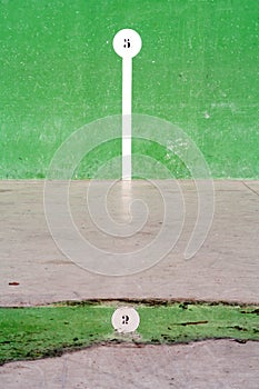 Basque pelota court with number reflection on puddle photo