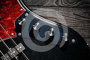 bass guitar preamp knobs on wood