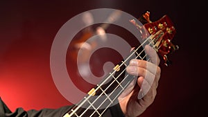 Bass guitar. Two guitarists play the guitar. Close up. Smoke background