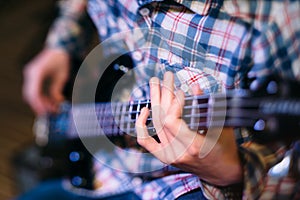 Bass player holding guitar neck focus