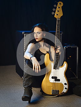 bass player sitting with her amplifier