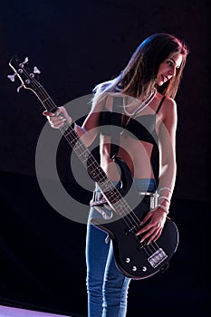 Bass-playing star, sexy attire, confident on stage photo