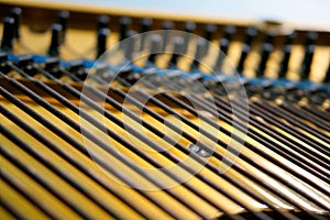 Bass strings strung in the old piano. The mechanism of musical instruments