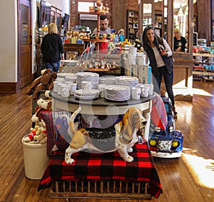 Basset Hound statue in front of a table of china in The Pioneer Woman Mercantile in Pawhuska Okla