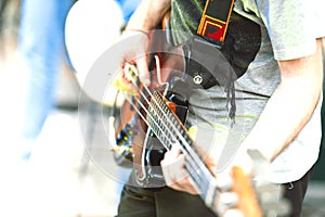 Bassist detail of a pop group during a show