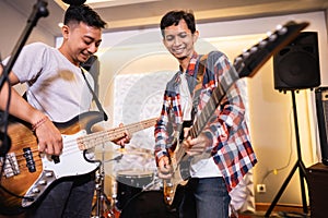 a bassist and guitarist enjoying playing musical instruments