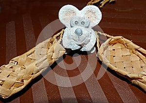 Bast shoes and little white mouse. Lapti - Russian old wicker traditional peasant shoes. According to the Eastern calendar