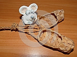 Bast shoes and little white mouse. Lapti - Russian old wicker traditional peasant shoes. According to the Eastern calendar