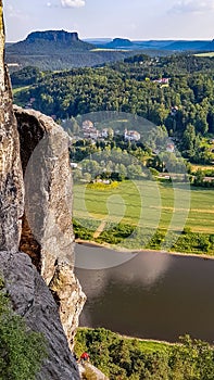 Bastei view of a climber and the town of Rathen, Saxony, Germany