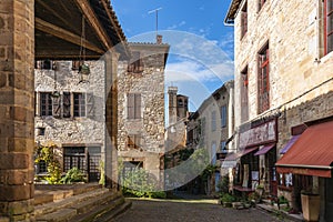 Old street in the medieval village of Cordes sur Ciel in autumn, in the Tarn, Occitanie, France photo