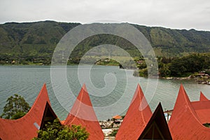 Batak-style houses with red roofs, Lake Toba, Indonesia.