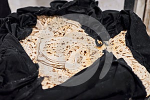 Batch of chapati round flatbreads in black bag for langar in sikh gurudwara temple, roti flatbreads