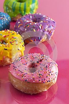 Batch of Rainbow Colored Glazed Donuts