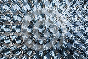 A batch of shiny metal cnc aerospace parts production - close-up flat lay with selective focus for industrial background