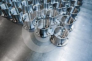 A batch of shiny metal cnc made aerospace parts production - close-up with selective focus for industrial background