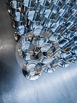 A batch of shiny metal cnc made aerospace parts production - close-up with selective focus for industrial background