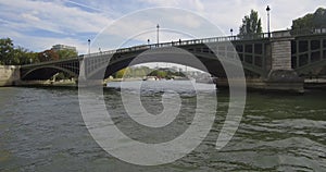 Bateau-mouche passing under the Pont de Sully in Paris