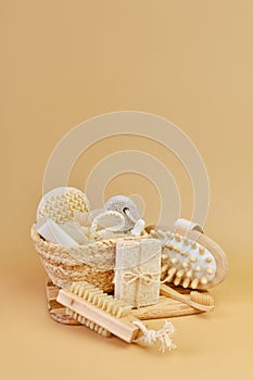 Bath accessories set in wicker basket on a beige background.