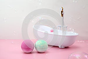 Bath bombs in bathroom, soap bubbles, bathtube miniature