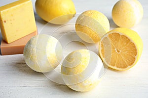 Bath bombs and lemon on white background