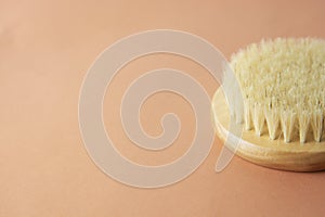 Bath brush made of bamboo isolated over brownm warm background, copy space. Zero waste product. No plastic concept.
