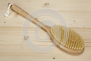 Bath brush on a tabletop of spruce wood