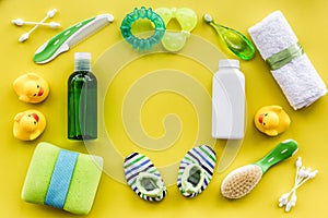 Bath cosmetic set for kids, towel and toys yellow background top view space for text