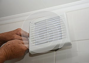 Bath fan repair, installation. Handyman installing new bath vent fan, ventilation system in the house bathroom