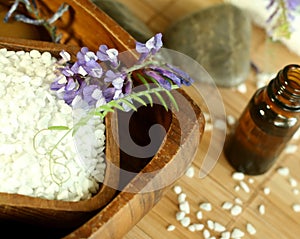 Bath salt and bottle of essence oil, stones and fl