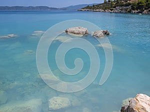 Bath in the sea with tourists and vacationers at the thermal healing hot springs of the Greek resort of Methana on the Peloponnese