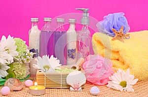Bath and Spa Products with flowers on Pink Background Soap