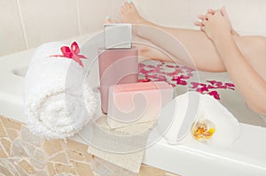 Bath time - cosmetics, towel and soap composition with woman bat