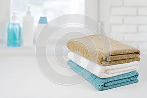 Bath towel pile on wood over defocused bathroom windowsill background