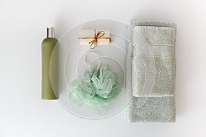 Bath towels with toiletries on white background. Flat lay, top view